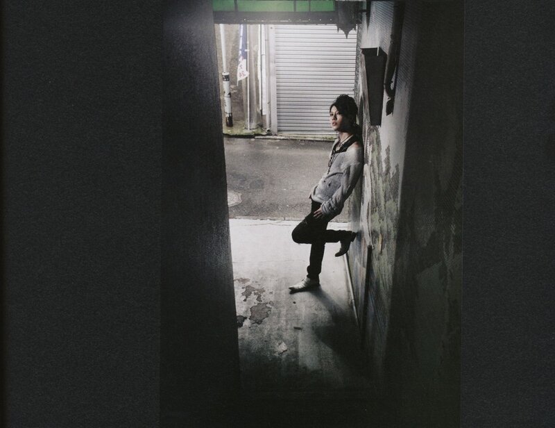 person leaning in alleyway