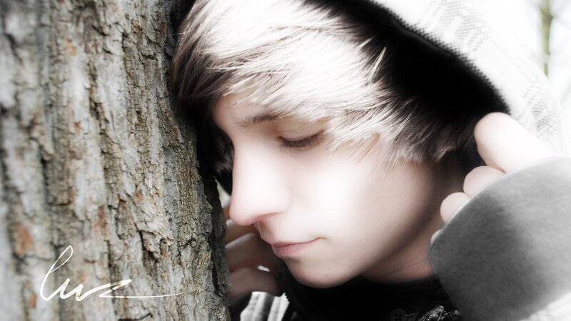 person leaning on tree