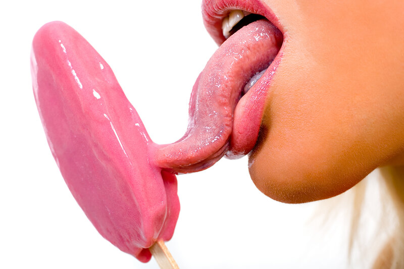 person licking pink ice cream