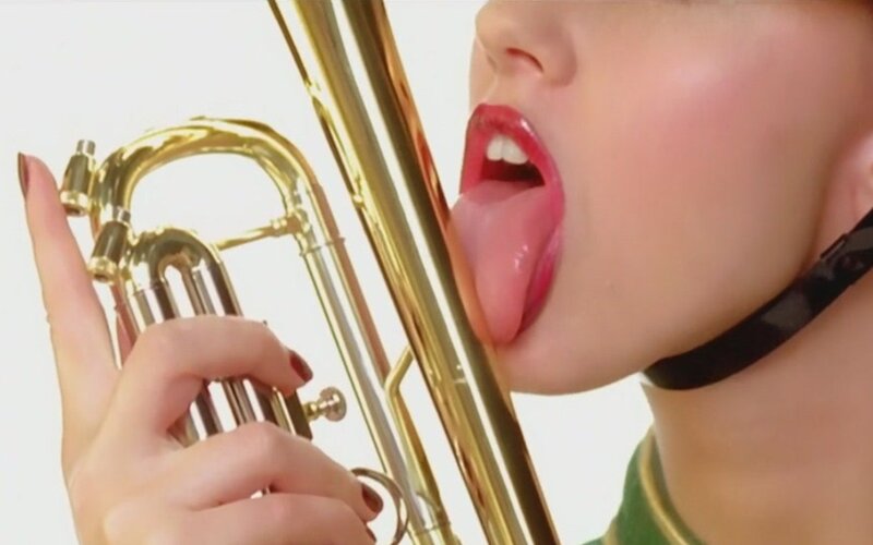 person licking trumpet