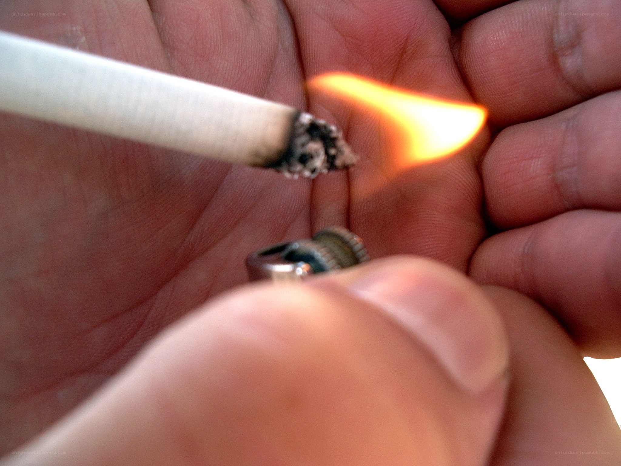 person lighting a cigarette