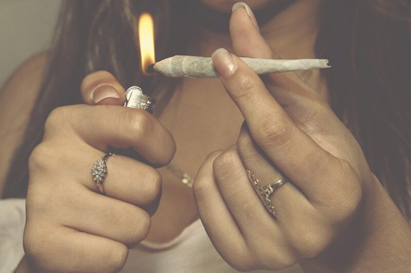 person lighting a joint