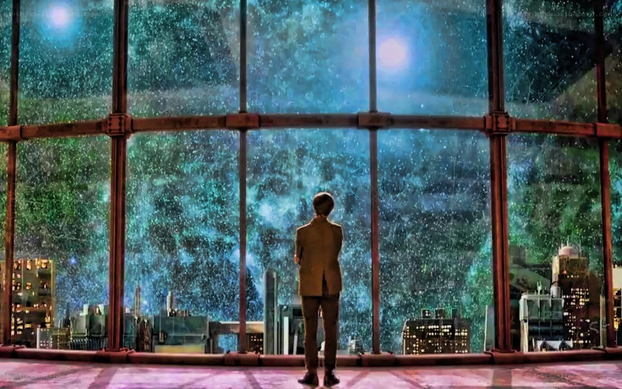 person looking at starry cityscape