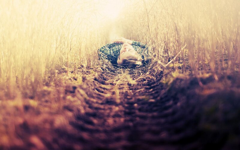 Person Lying in Field — Yellow