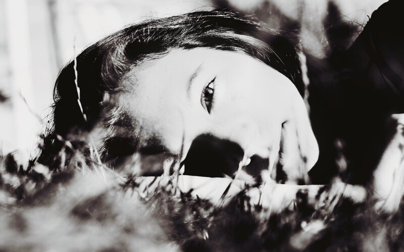 Person Lying in Grass — Black, Dramatic