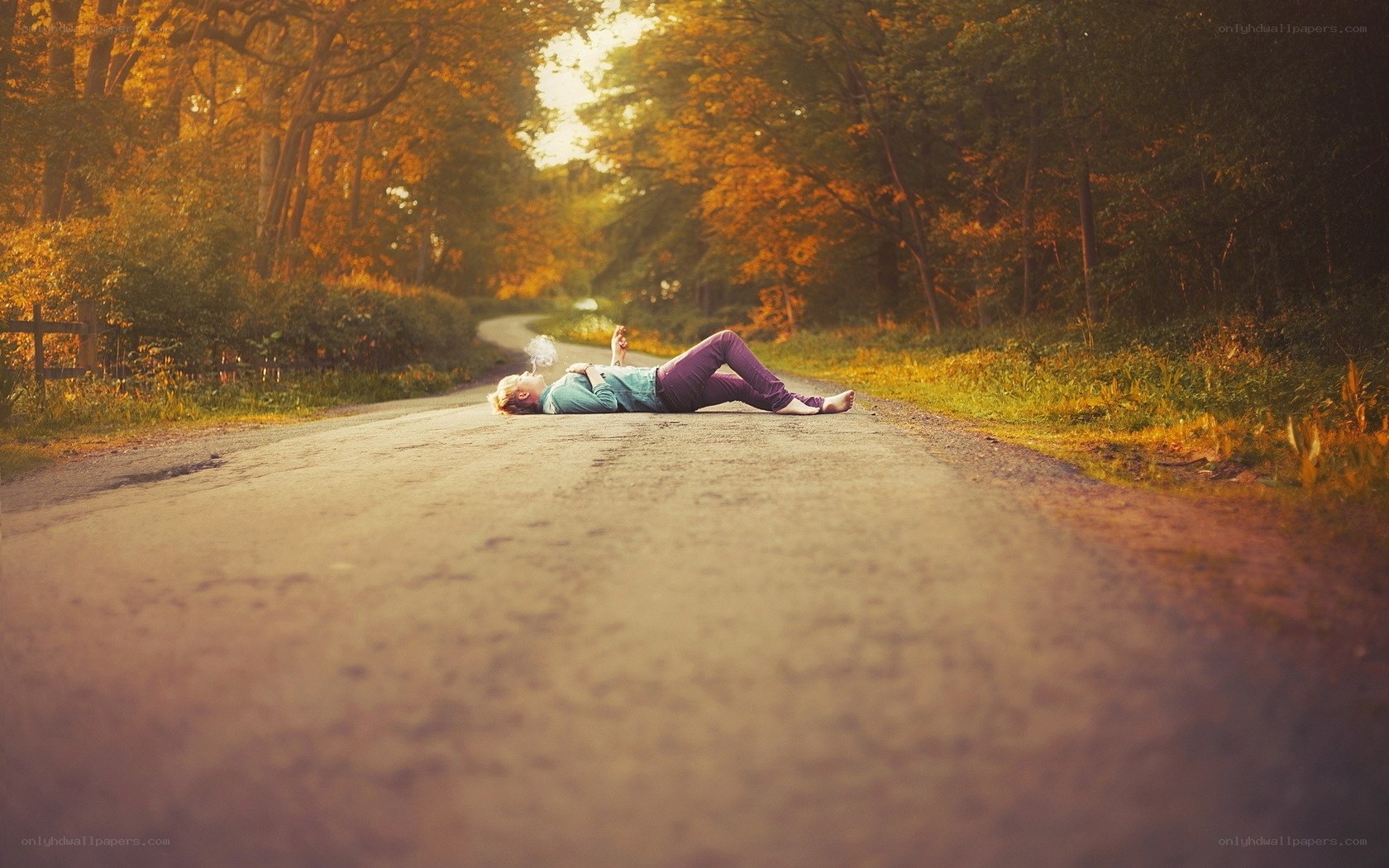 Person lying on a forest road
