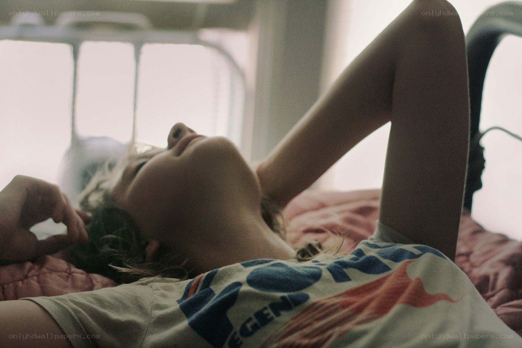 person lying on bed in daylight