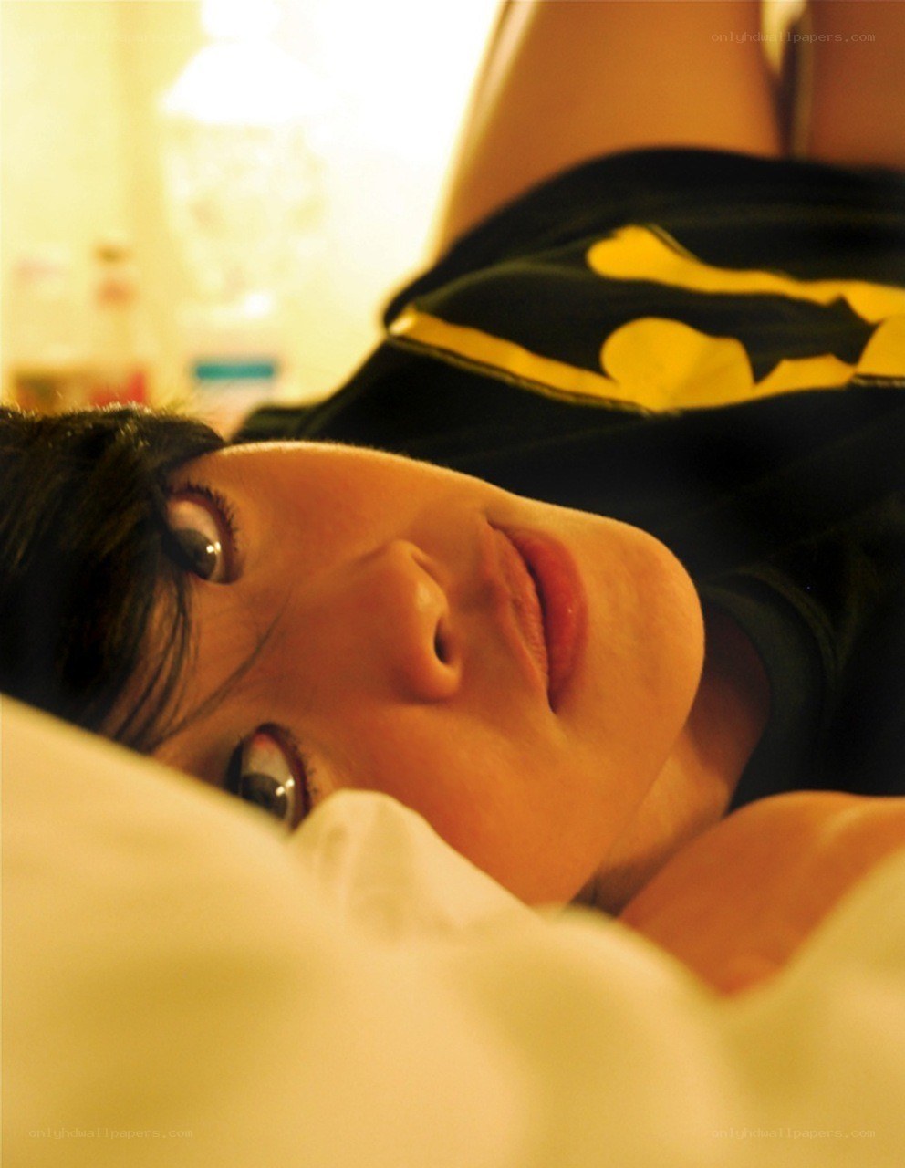 person lying on bed in warm light