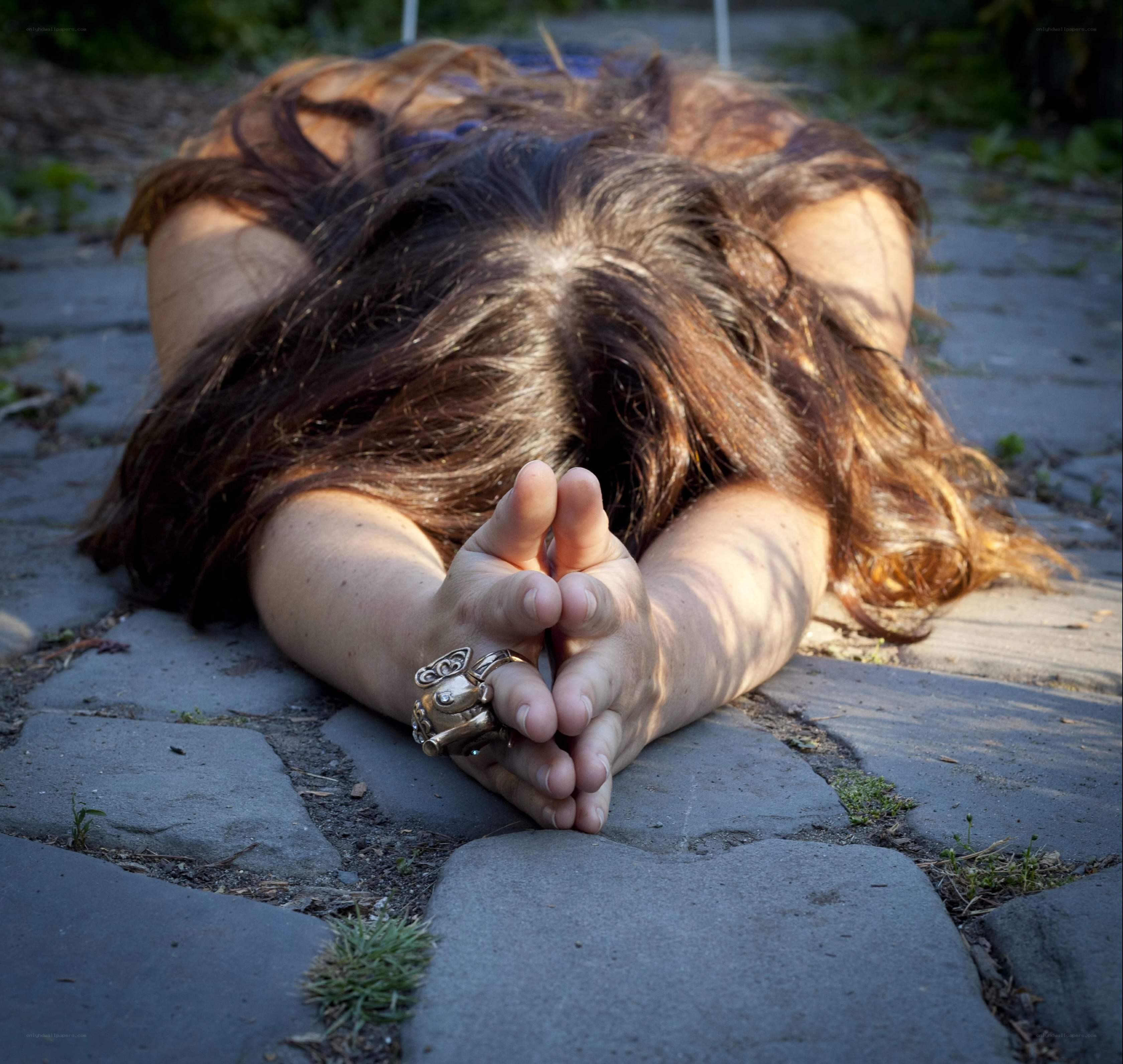 person lying on cobblestones