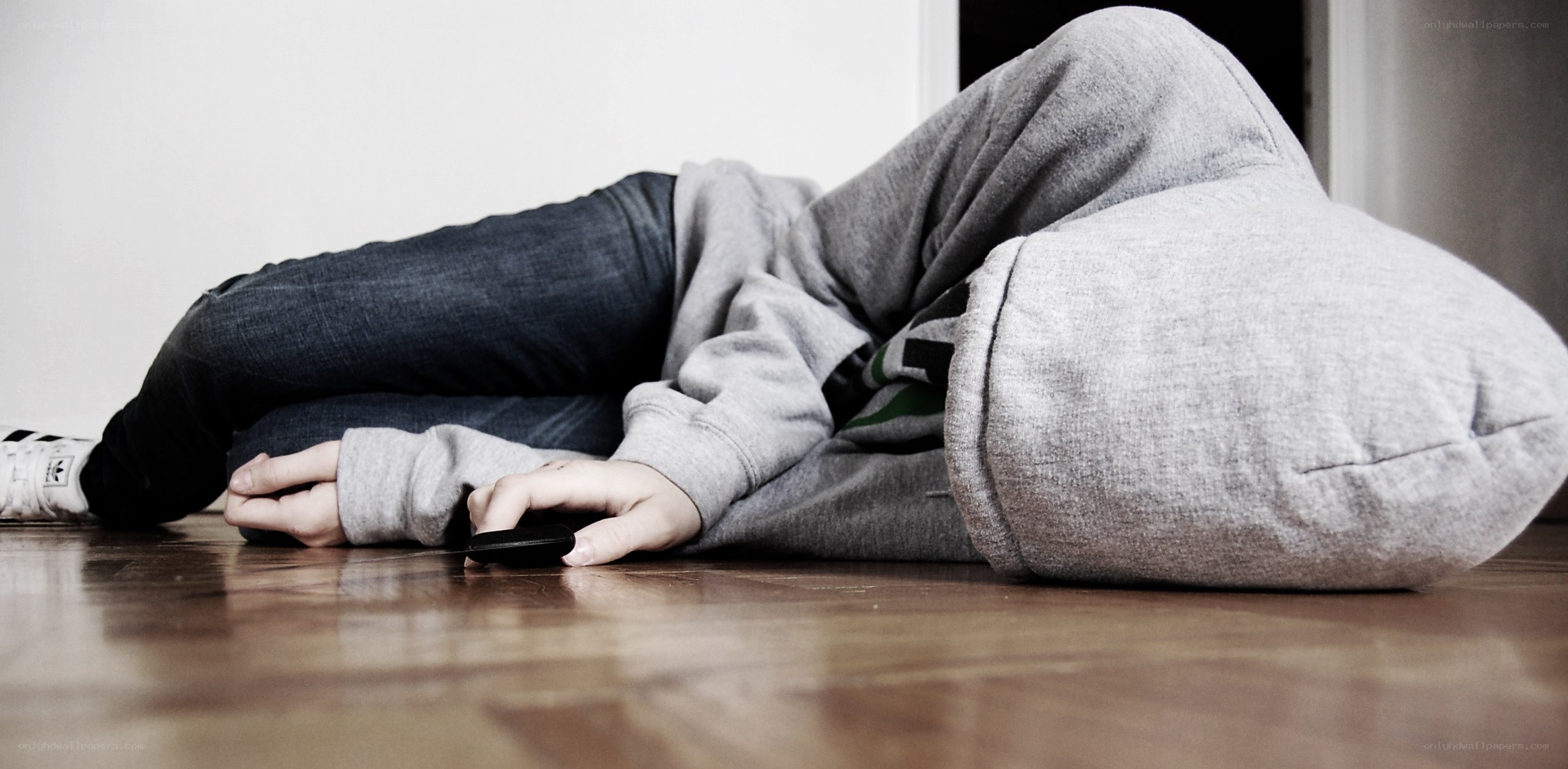 Person lying on floor with phone