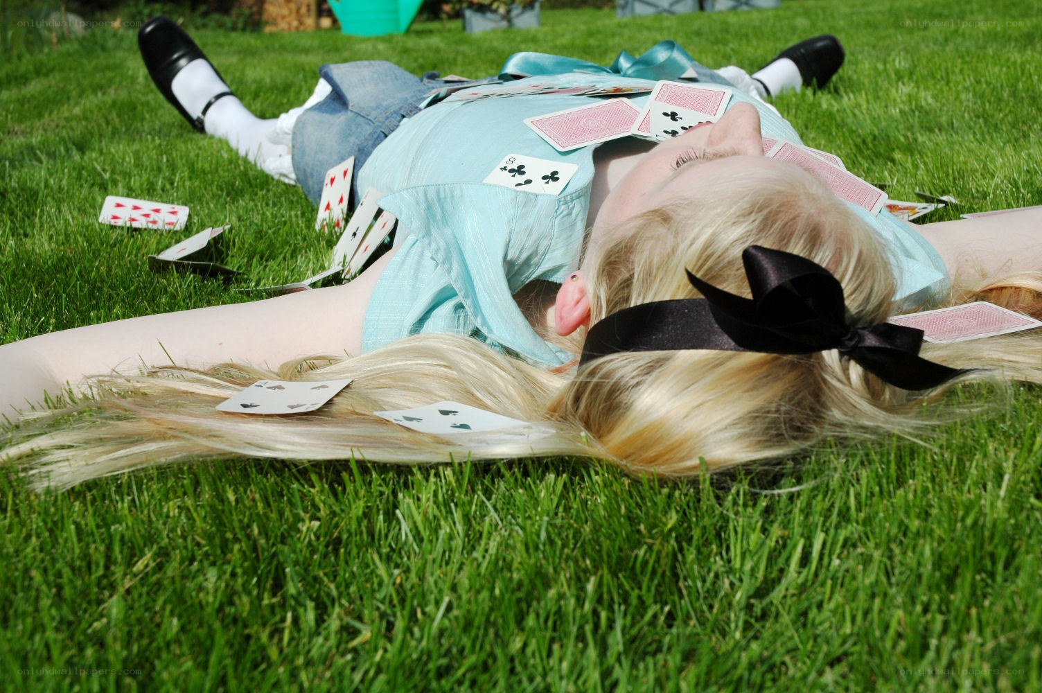 person lying on grass with cards