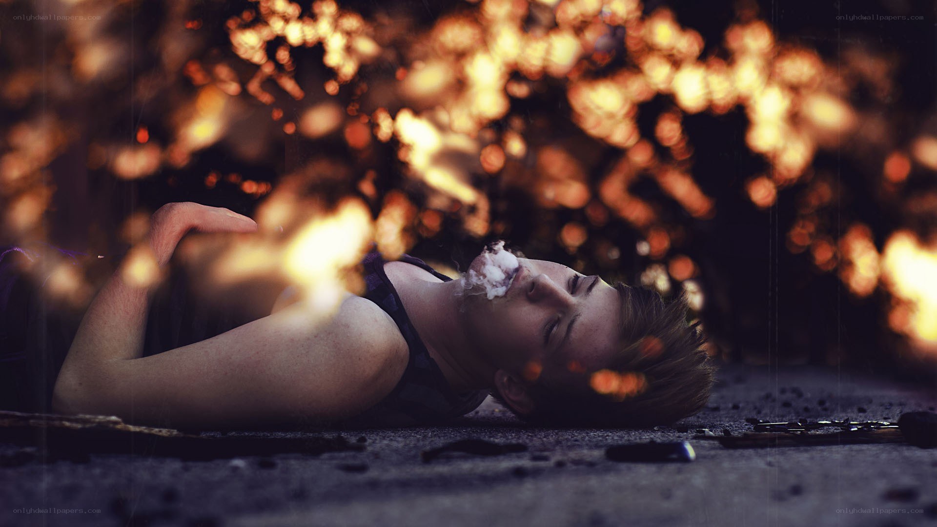 person lying on ground with fire