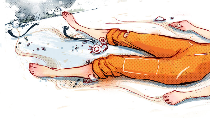 person lying on ground with headphones