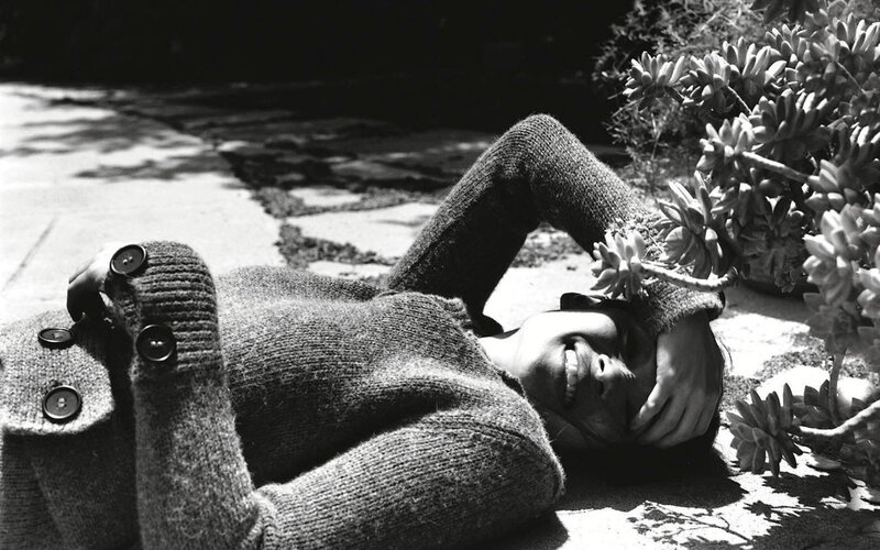Person lying on ground with succulent