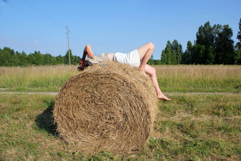 Person Lying on Hay Bale