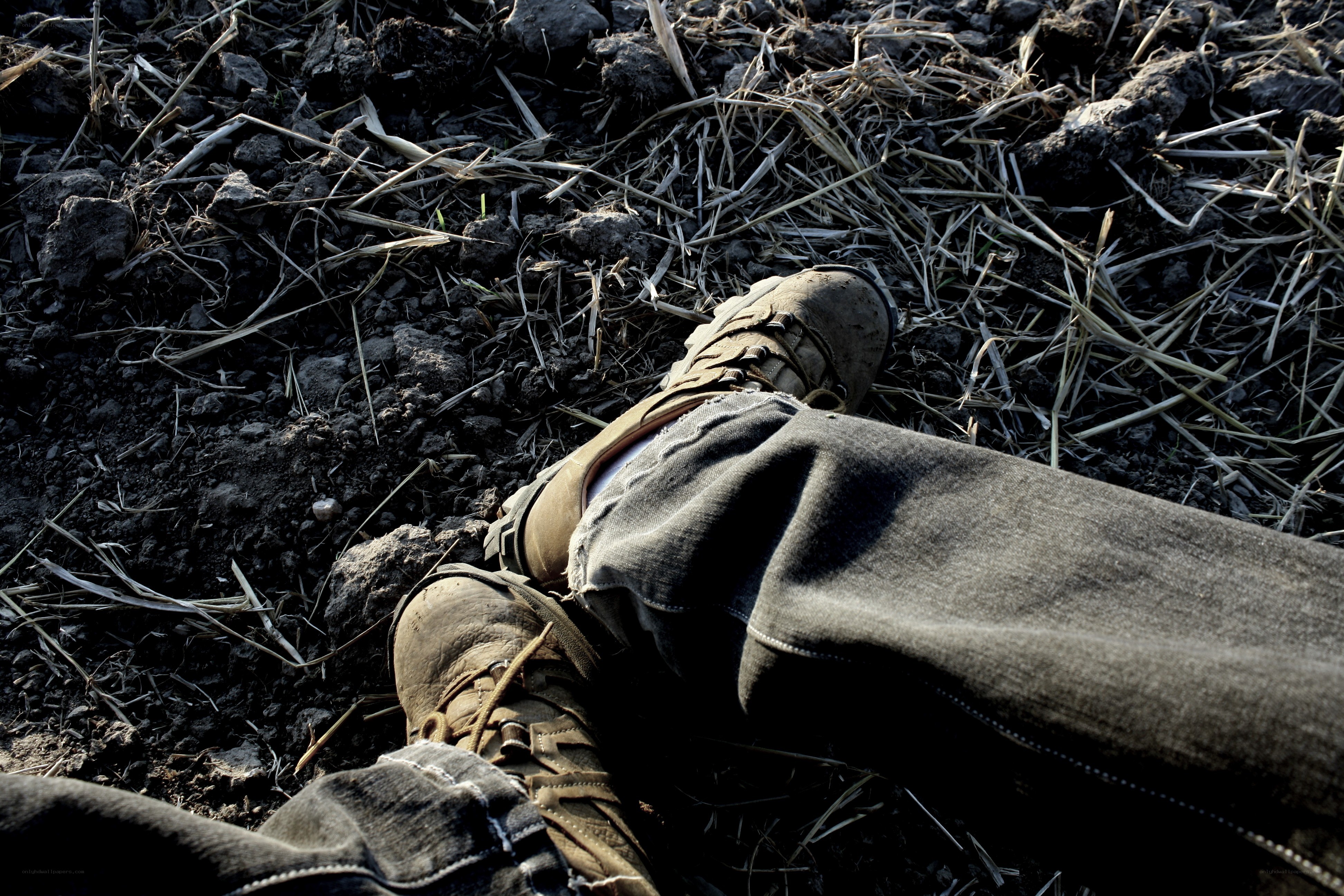 person lying on muddy ground