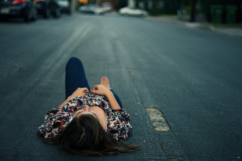 person lying on street