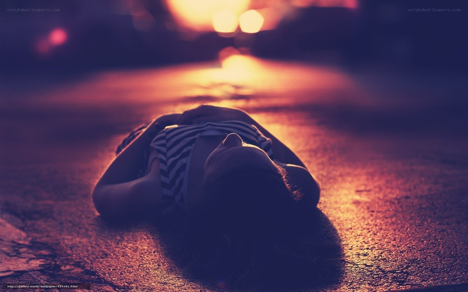 person lying on street at night