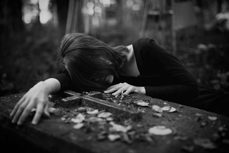 Person Lying on Tombstone