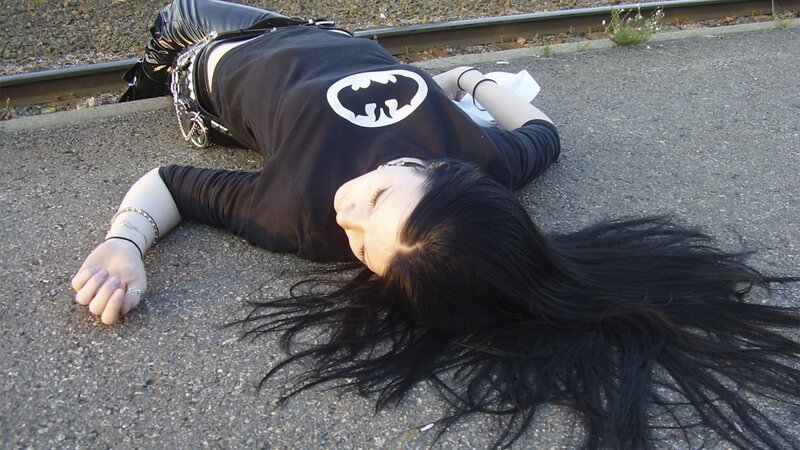 Person lying on train tracks
