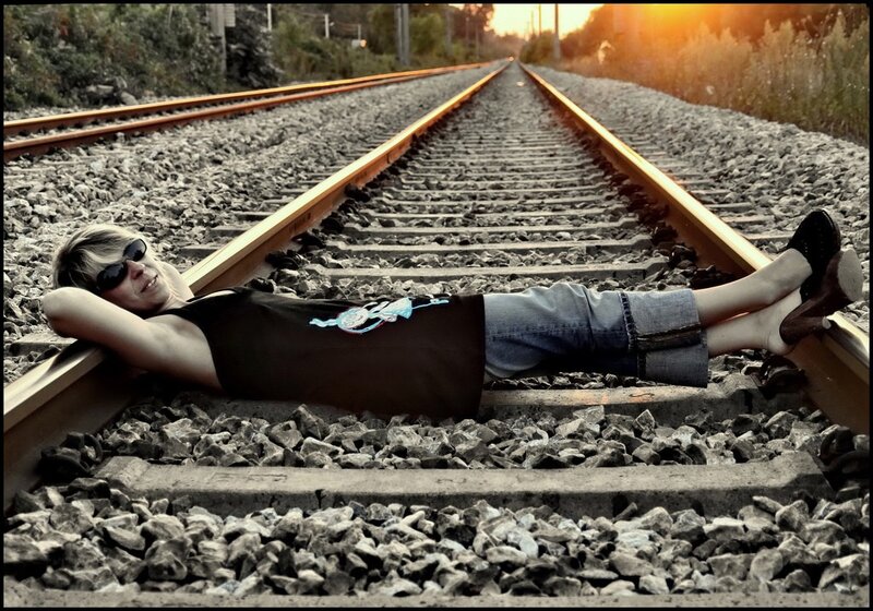Person Lying on Train Tracks — Gray, Dramatic