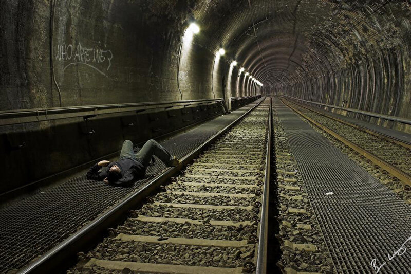 Person lying on train tracks
