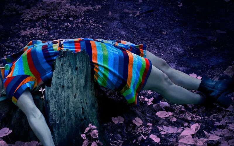 Person Lying on Tree Stump — Blue