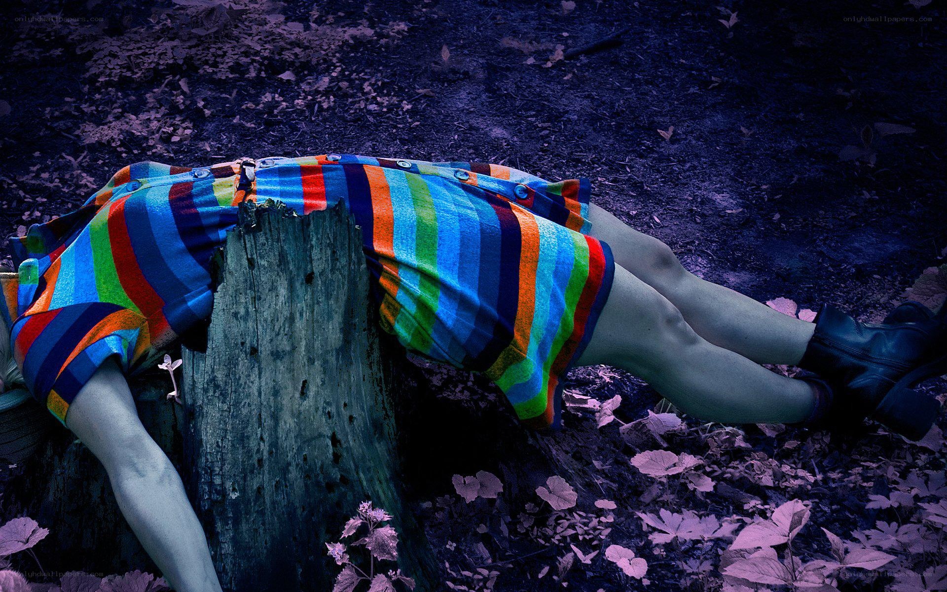 person lying on tree stump