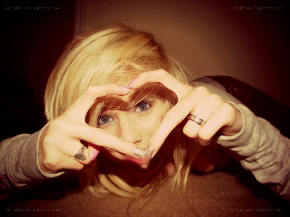 person making heart shape with hands
