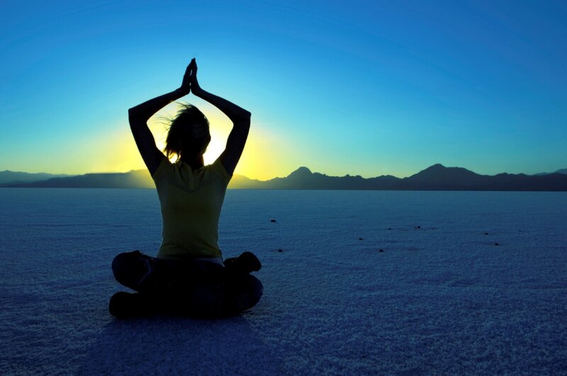 Person Meditating at Sunset