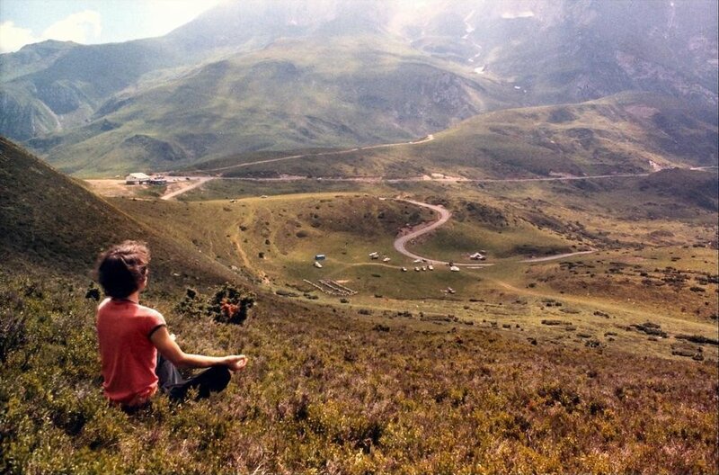 Person meditating in mountain valley