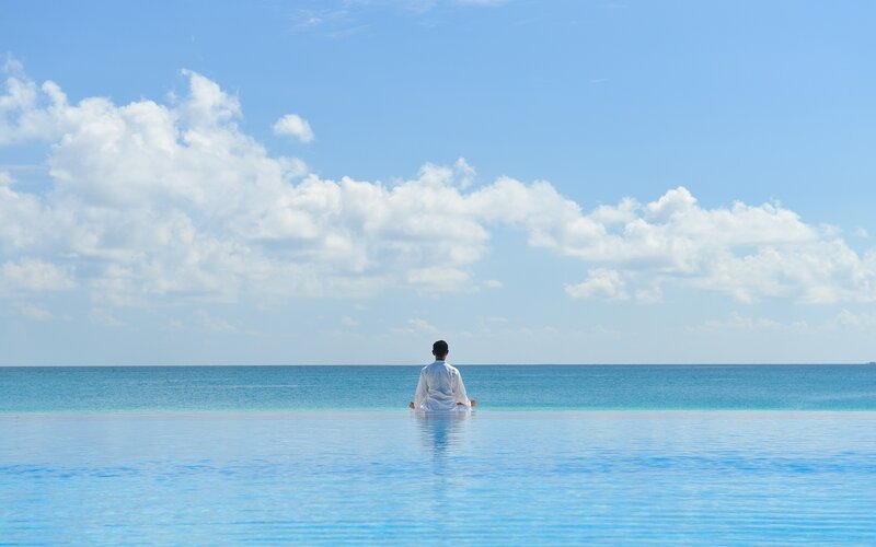 Person Meditating in Pool — Blue, Serene
