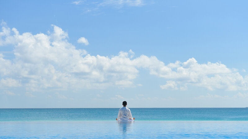 Person Meditating in Pool — Blue