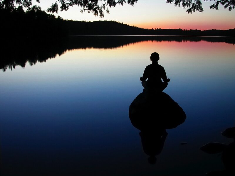 Person Meditating on Rock — Blue