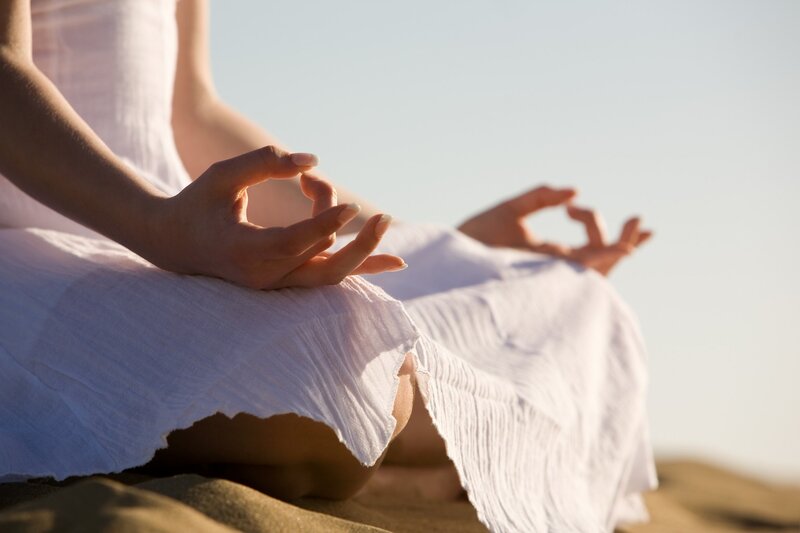 Person Meditating on Sand