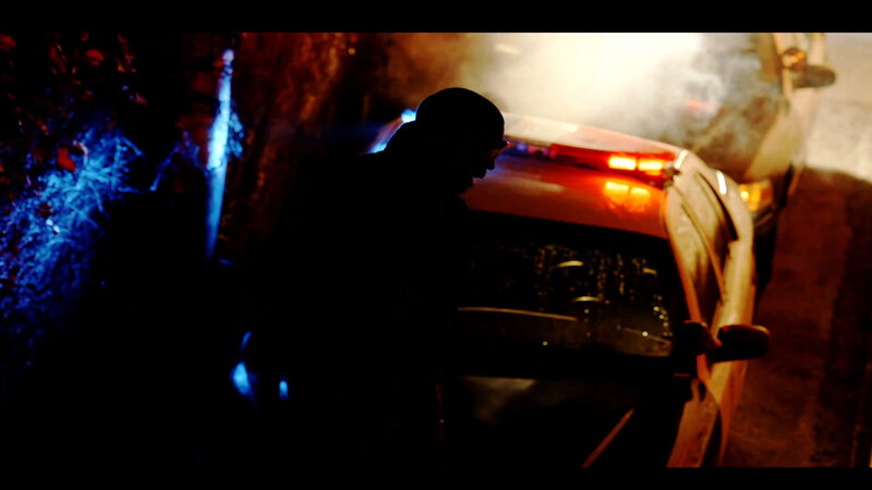 person near damaged car at night