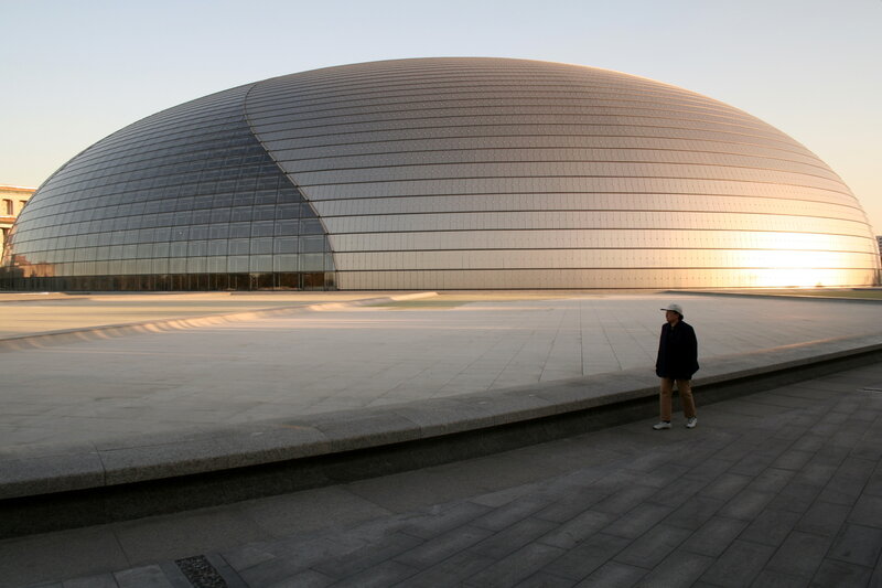 Person near modern dome building