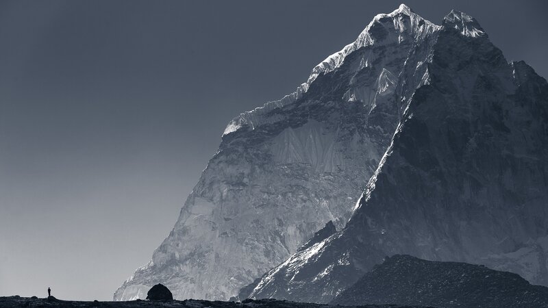 Person Near Snow-covered Mountain