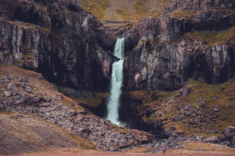 Person Near Waterfall — Green, Dramatic, Photograph, Cliffs