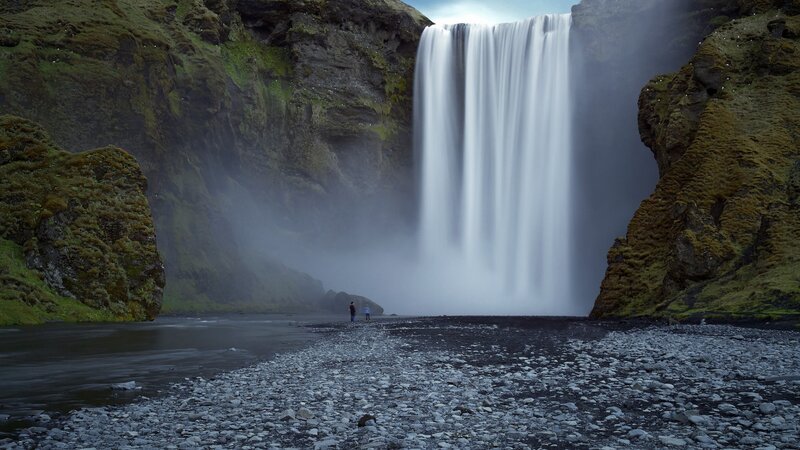 Person Near Waterfall — Green, Dramatic