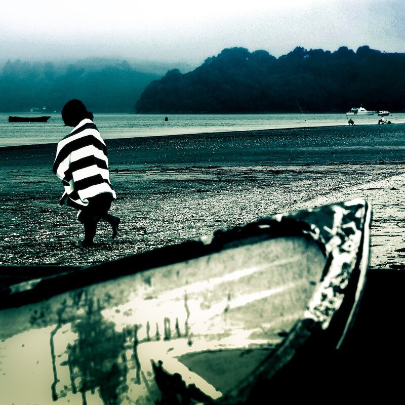 Person on a beach with boat
