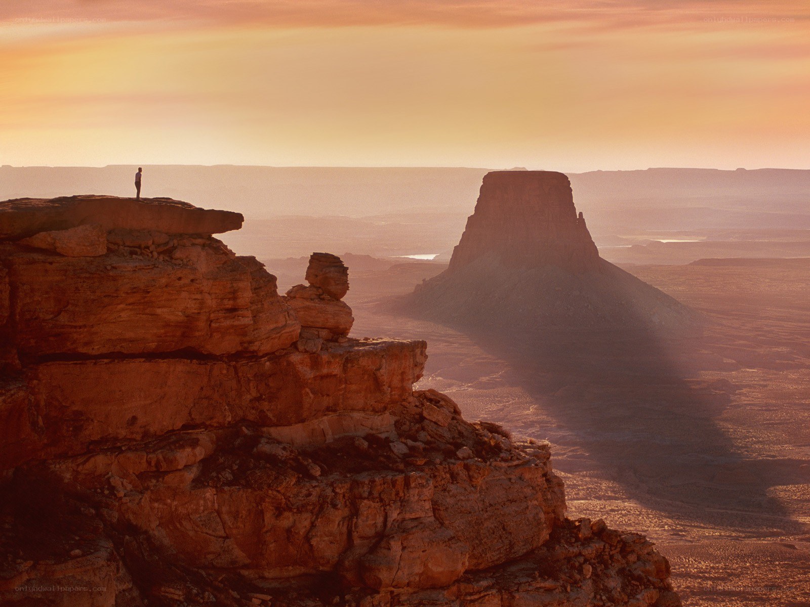Person on a cliff at sunset