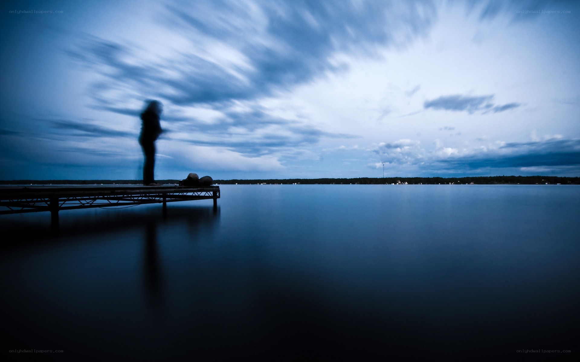 Person on a dock at dusk