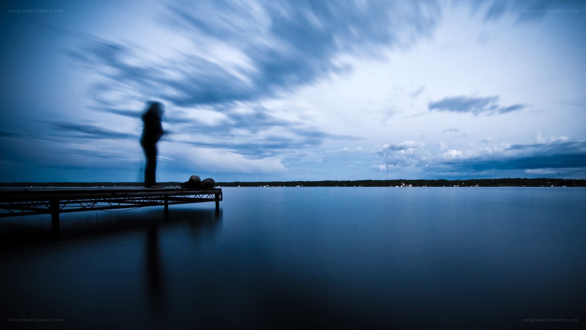 Person on a dock at dusk