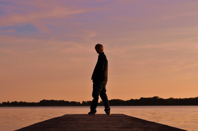 Person on a dock at sunset