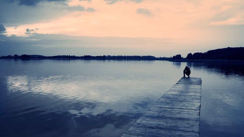 Person on a dock at sunset