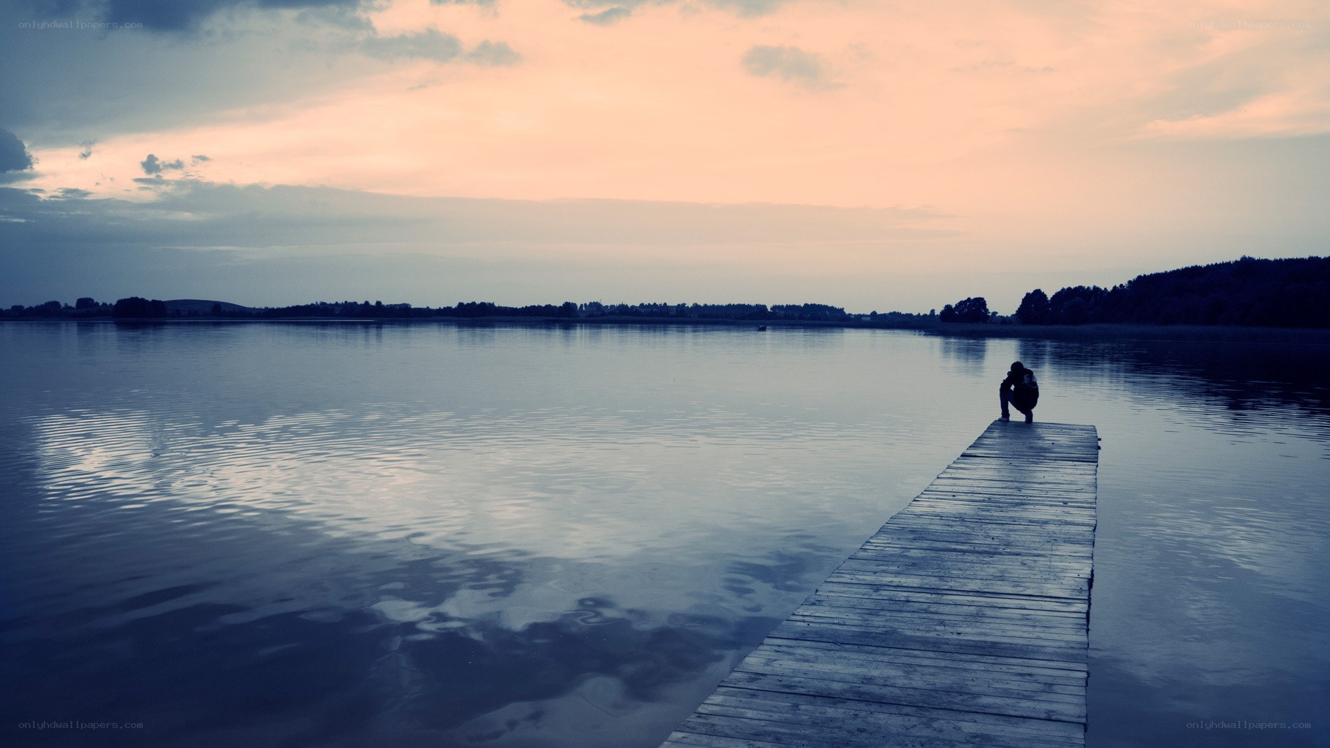 Person on a dock at sunset