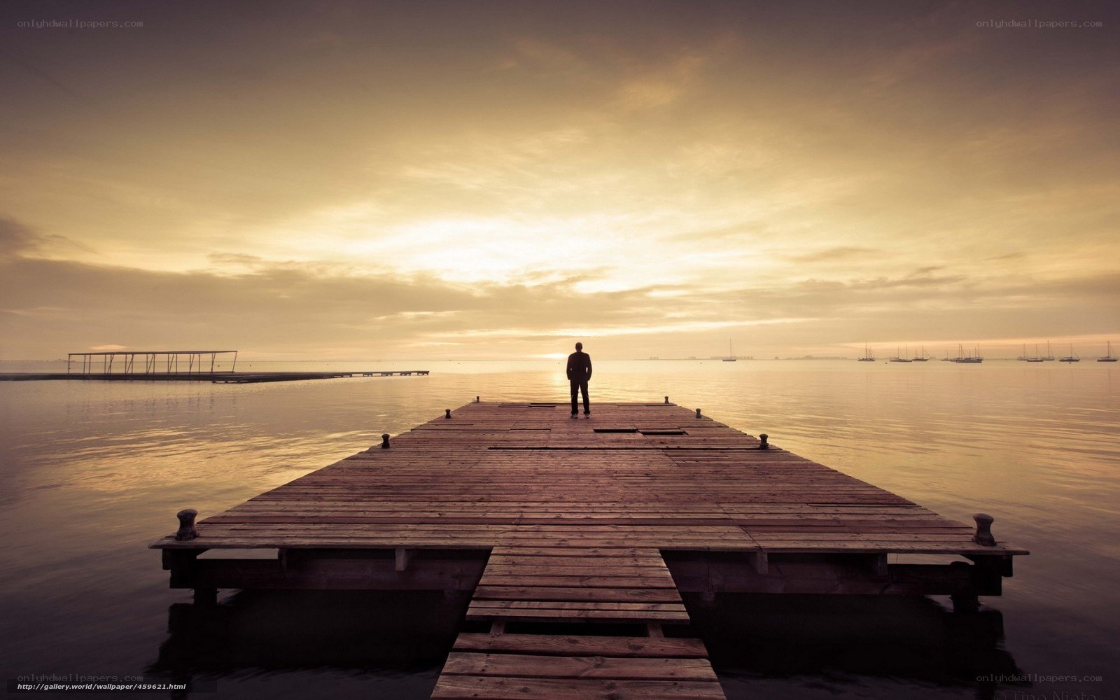 Person on a dock at sunset