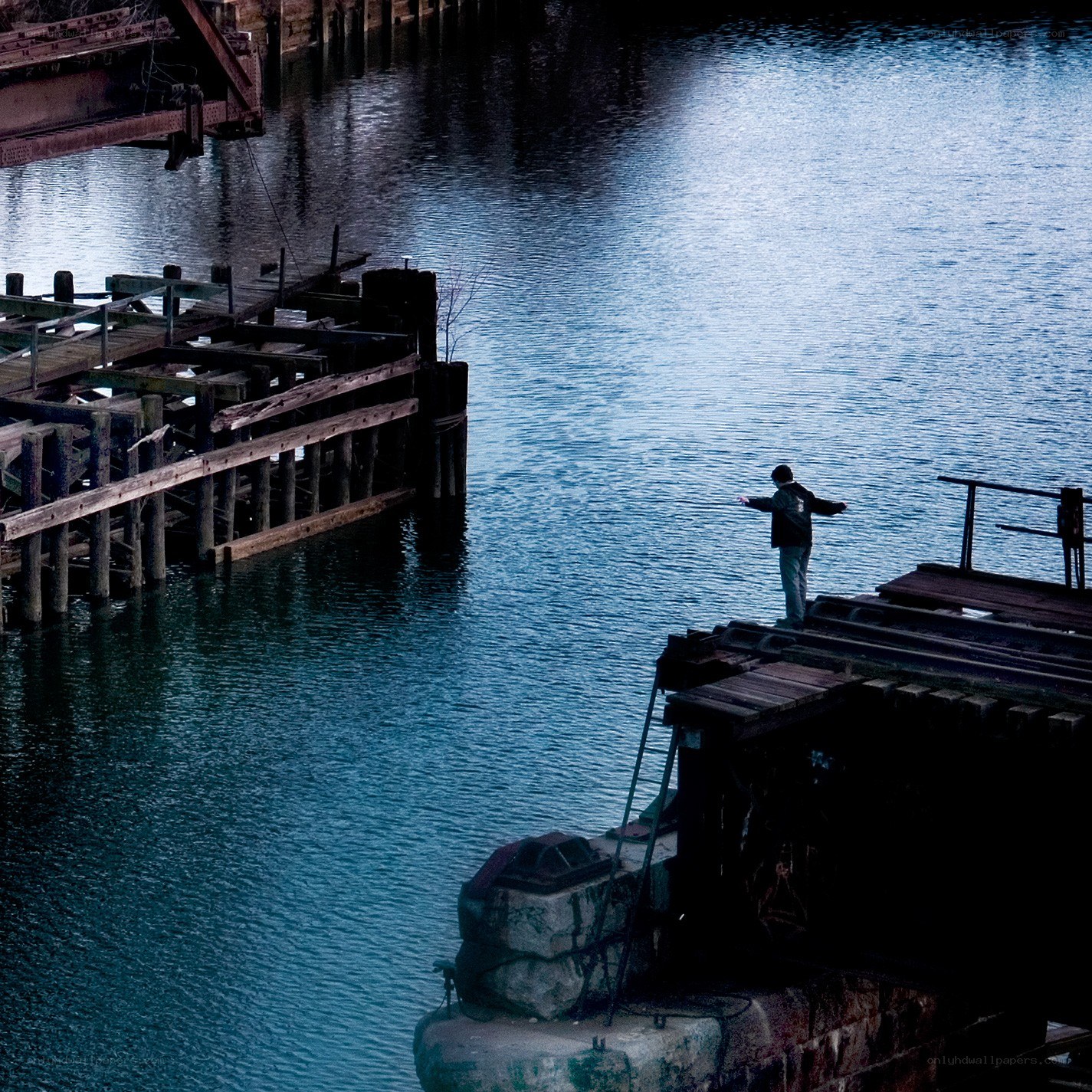 person on a dock by water