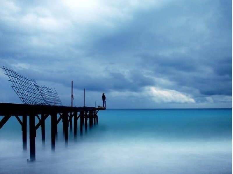 Person on a pier at dusk